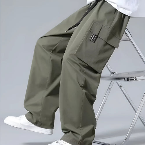 Boys' straight-leg cargo trousers in army green with large pockets and a drawstring waistband.