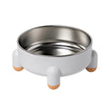 Green non-slip stainless steel pet bowl with high foot base on a floor.