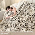 Double-layer cationic leopard jacquard taffeta blanket showing reversible design with zebra pattern