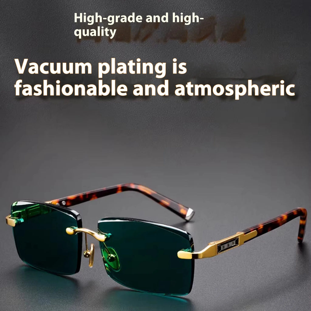 Frameless dark green crystal sunglasses with metal arms on a table next to their hard case.