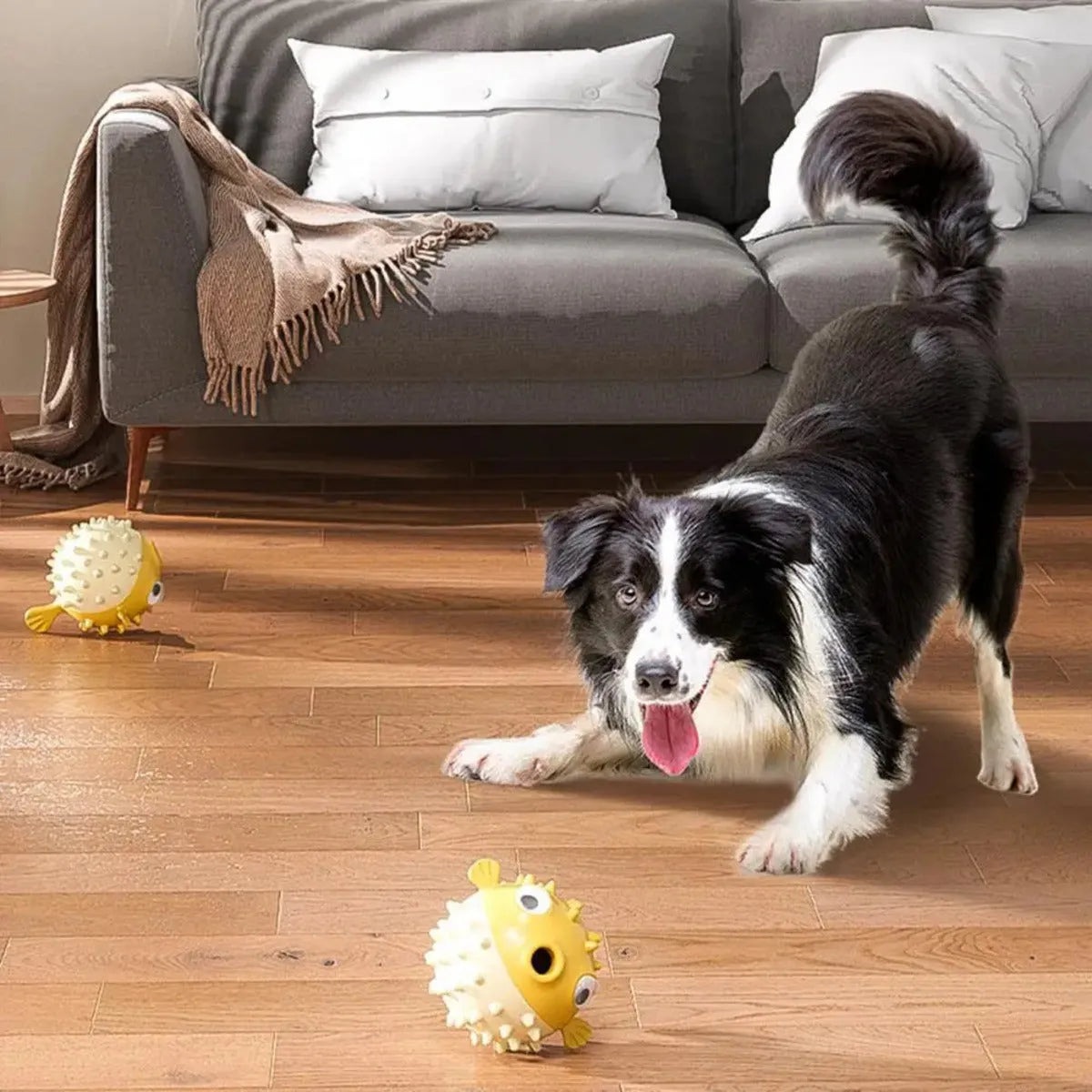 Yellow vinyl fish-shaped dog chew toy with textured surface and squeaker.