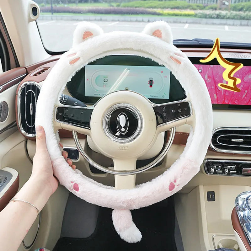 Plush steering wheel cover with embroidered bear design, shown fitted on a car steering wheel.