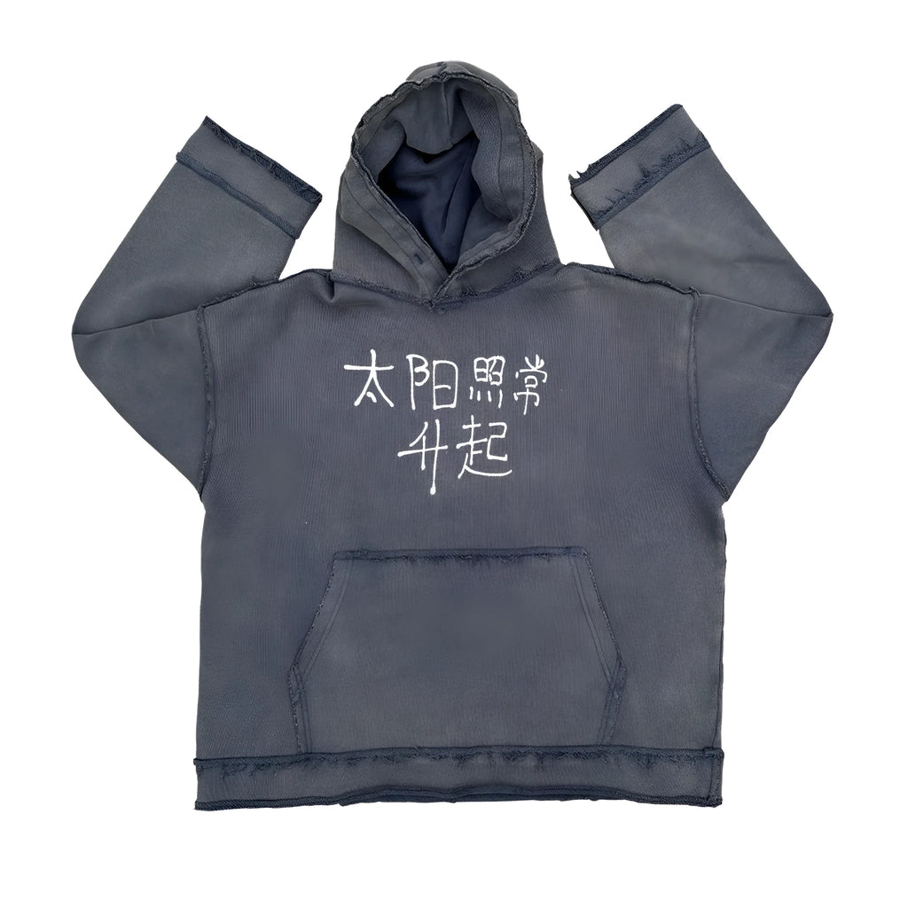 Reverse dark blue hoodie sweater on a model, showing knitted texture and hood.
