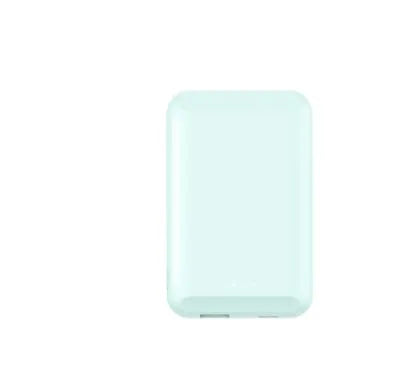 A black magnetic wireless power bank attached to the back of an iPhone for charging.