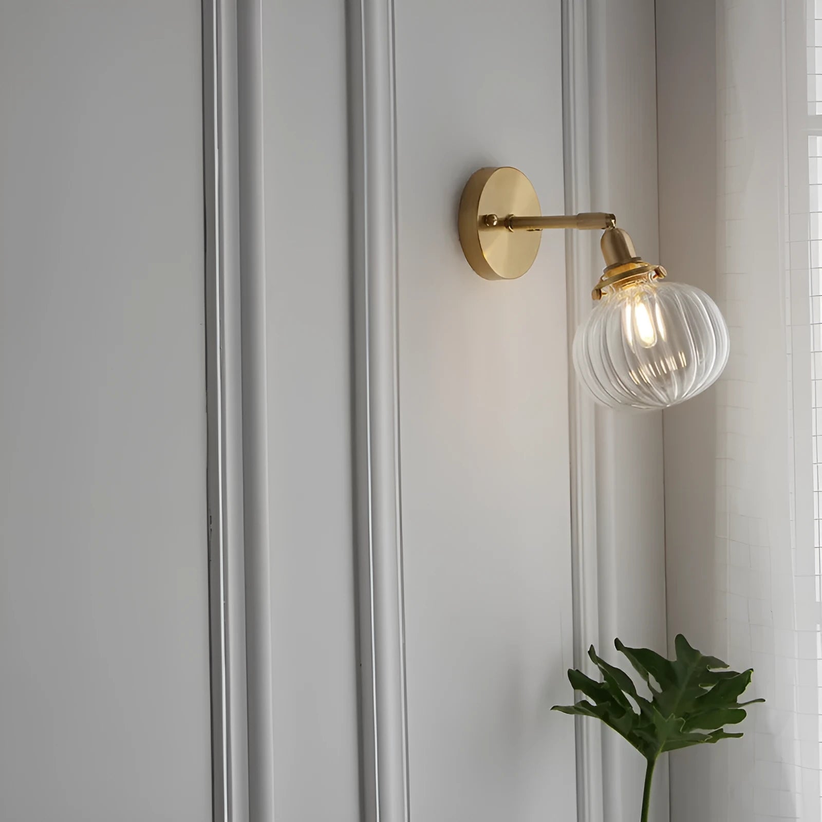 Creative pumpkin-shaped wall lamp with water ripple textured glass shade in blue, mounted on a white wall.