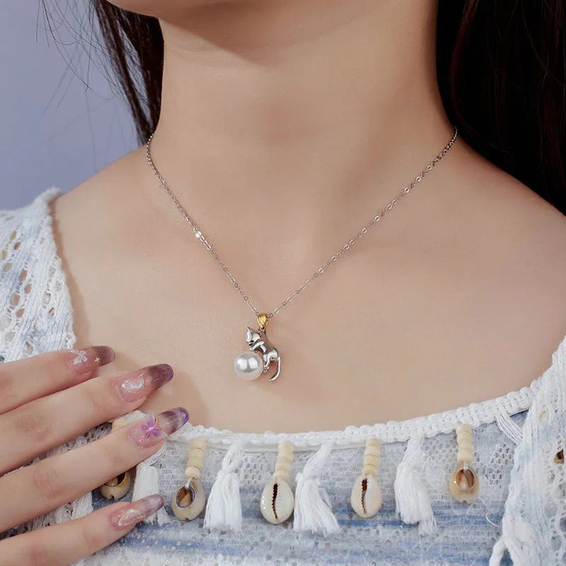 Sterling silver clavicle-length necklace with a cat charm pendant.
