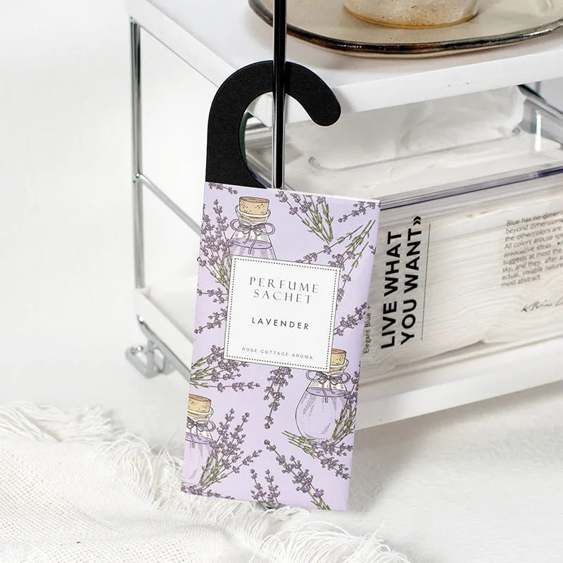 Pack of five household wardrobe sachets with lavender, rose, jasmine, sandalwood, vanilla, apricot blossom aromas on a shelf