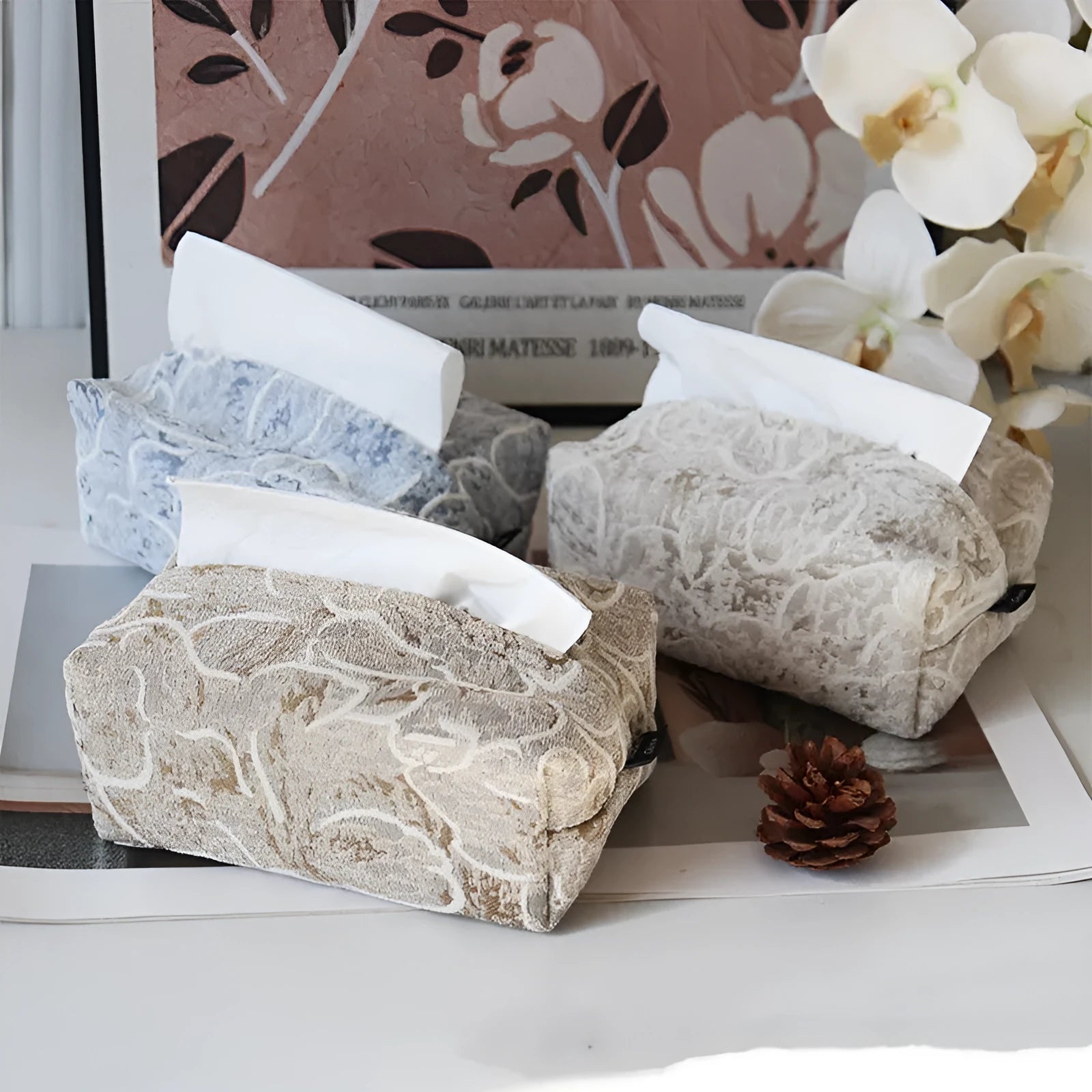 Chinese style floral cotton tissue box cover in beige, blue, and brown on a wooden table.