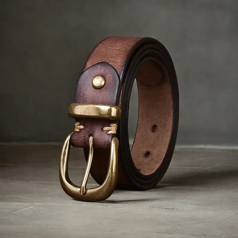 Men's brown casual leather belt with a copper pin buckle shown on a pair of jeans