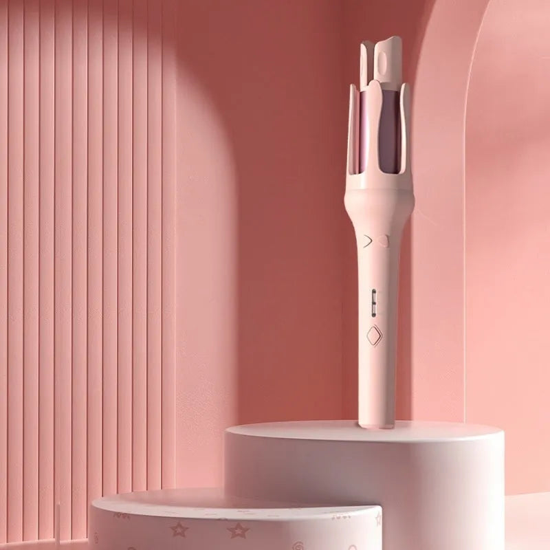 White and pink automatic hair curler with 32mm ceramic barrel and auto-clamp feature on a table.