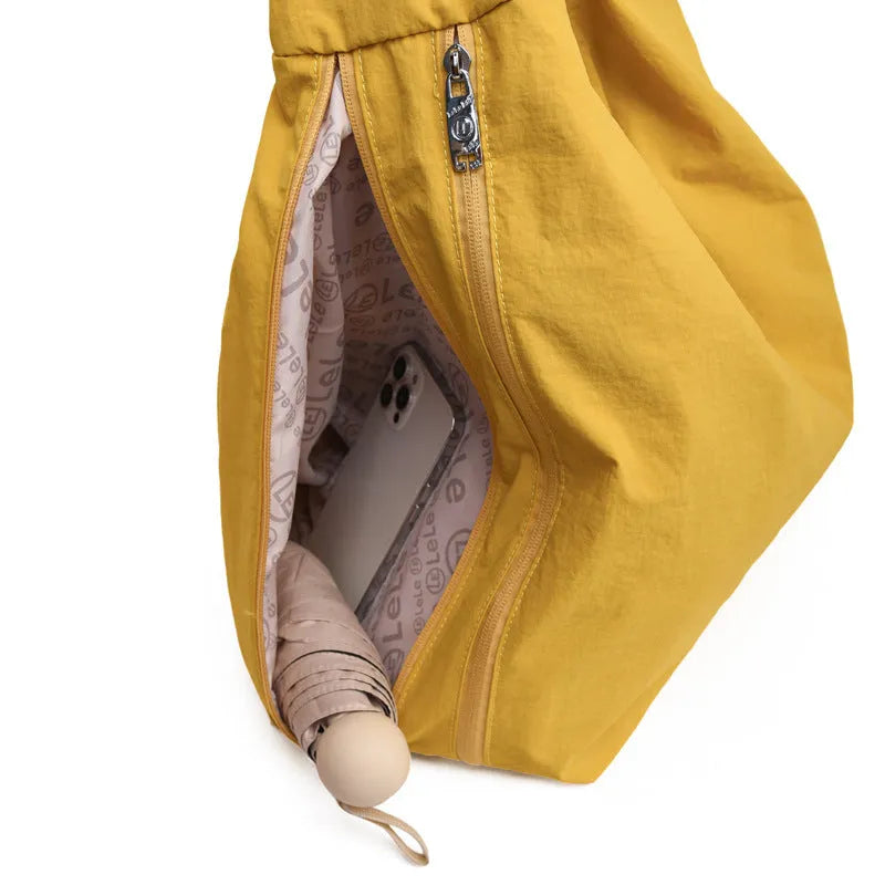 Soft heart-shaped nylon underarm bag for women shown in black, blue, khaki, and yellow.