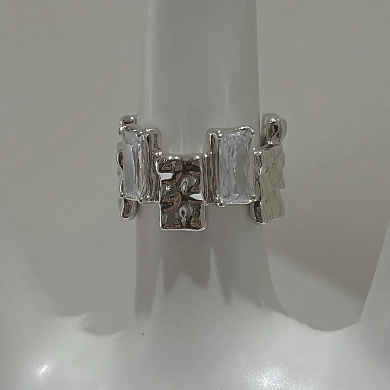 Silver geometric open ring with three-dimensional decoration and cross zircon design