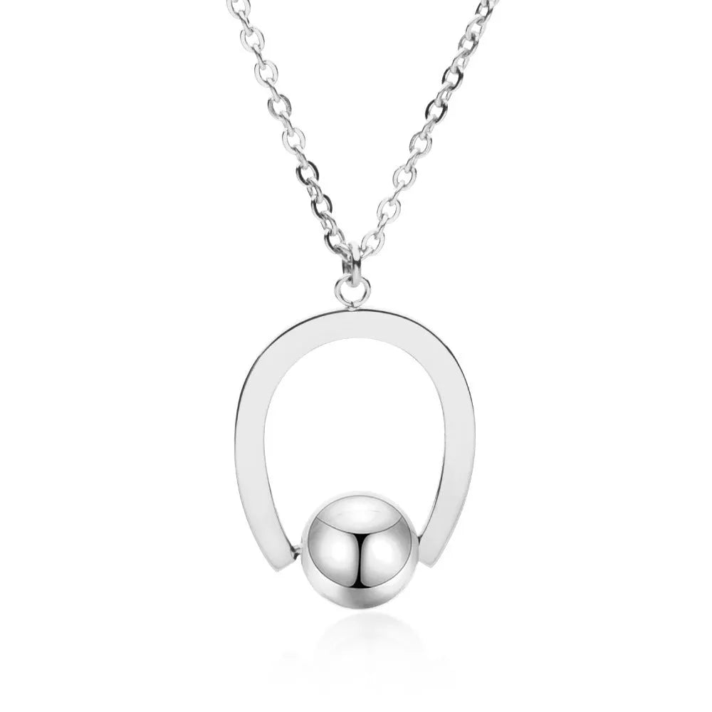 Gold tone stainless steel necklace with geometric pendant on a cross chain, shown adjusted to a medium length.