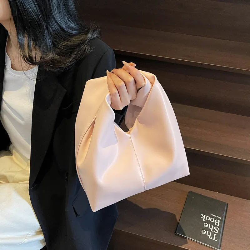 PU women's casual handbag in dumpling shape with sandwich pocket, shown in multiple colours.