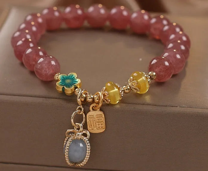 Red adjustable bracelet with strawberry quartz beads, alloy charm and rhinestone detailing