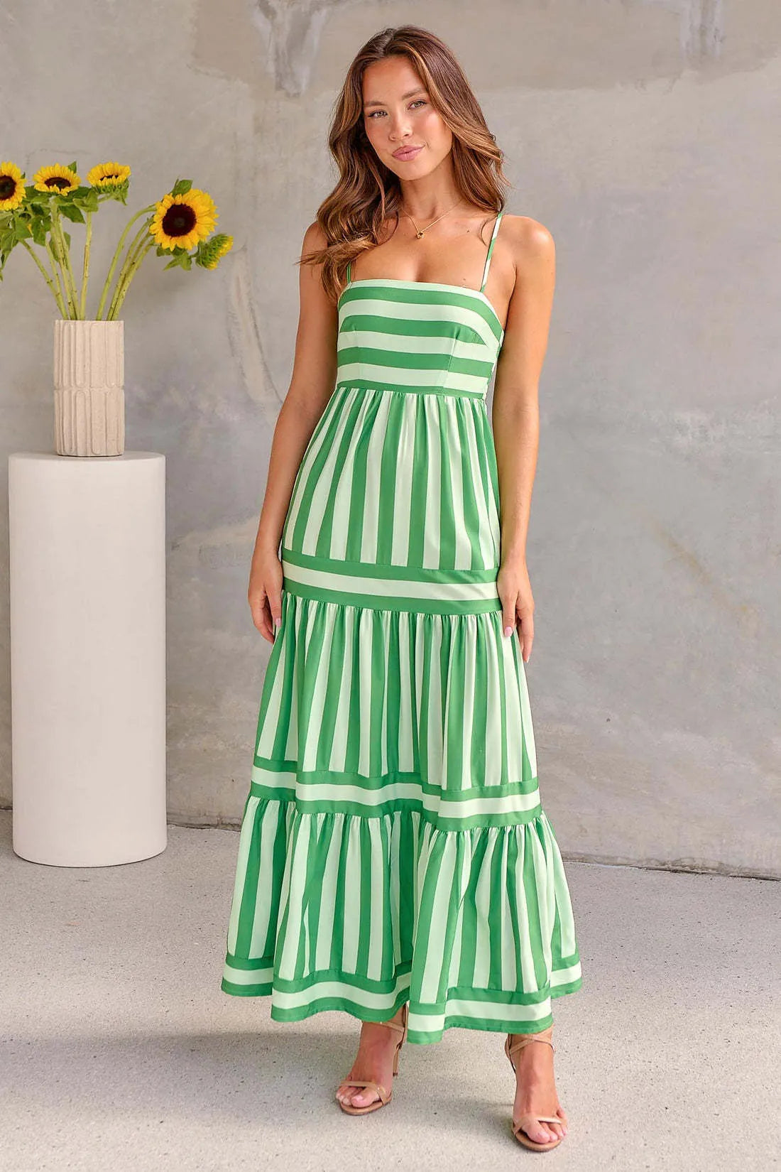 Long striped backless summer dress with square neckline and side pockets on a mannequin