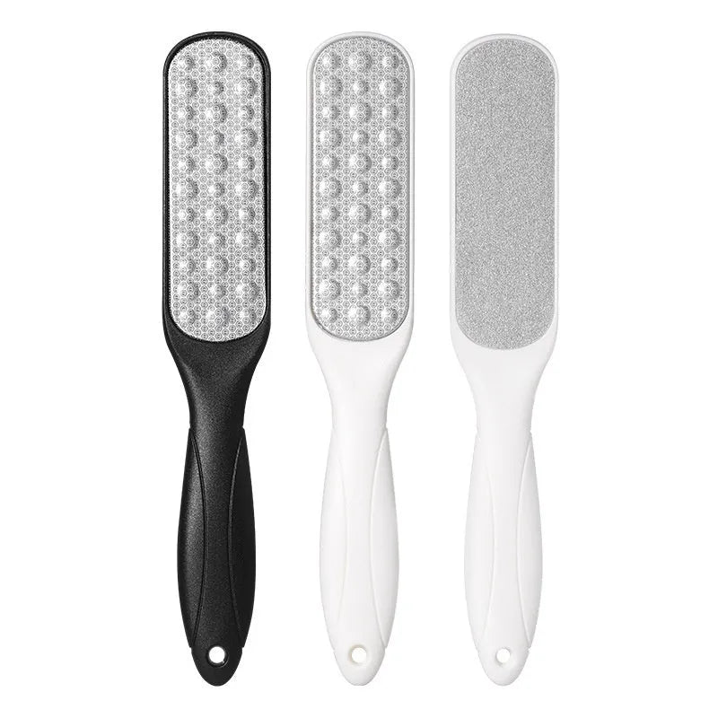 Stainless steel foot grinder file with attached sandpaper pad and separate black and white refill packs.