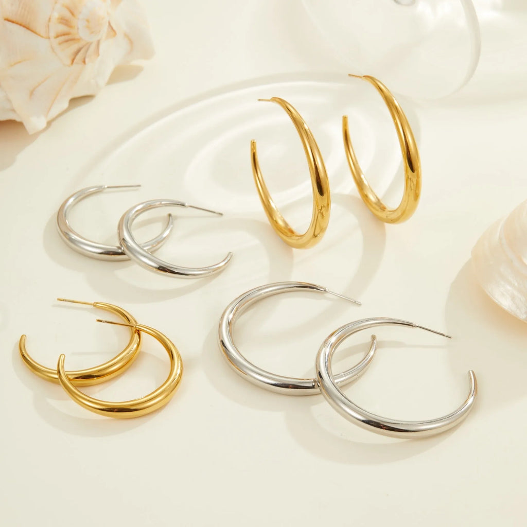 Titanium steel hoop earrings with round geometric shape and vacuum PVD gold plating