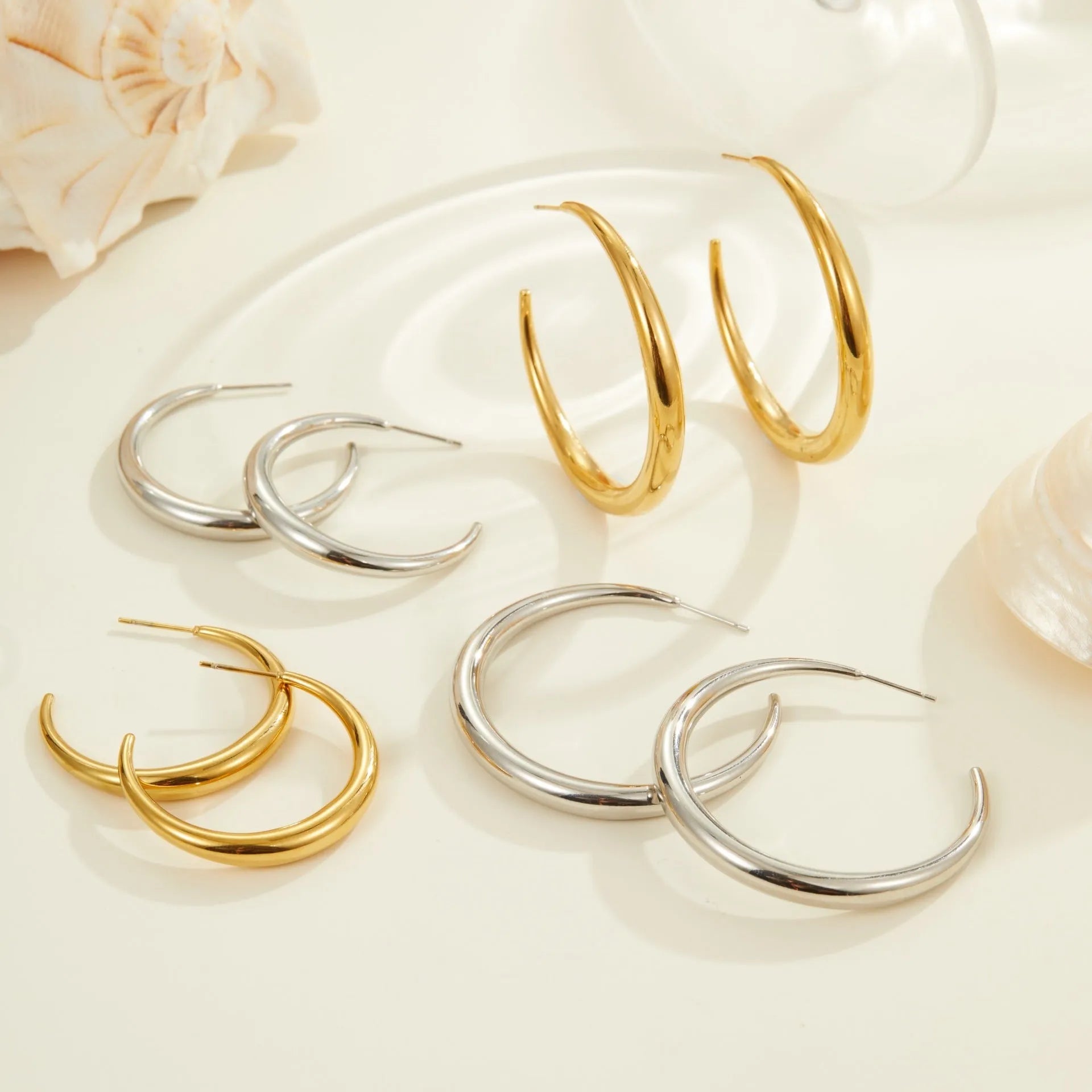 Titanium steel hoop earrings with round geometric shape and vacuum PVD gold plating