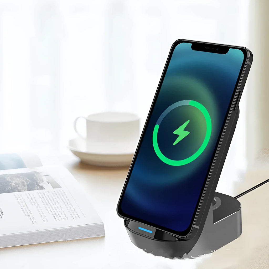 Black grey foldable wireless charging stand holding a mobile phone vertically, with slots for a smartwatch and earbuds case.