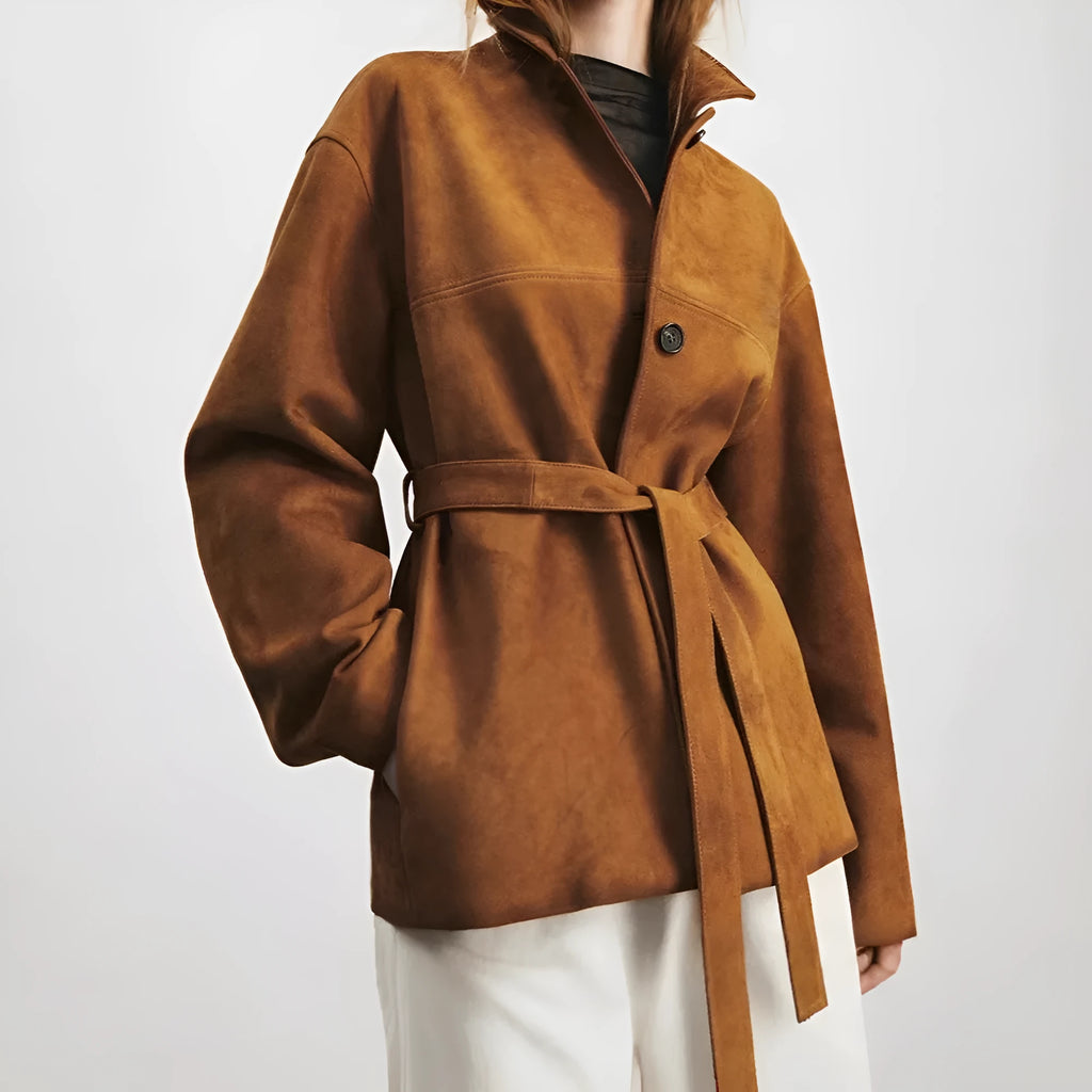 Yellow brown retro women's coat with Peter Pan collar and leather belt on a hanger.