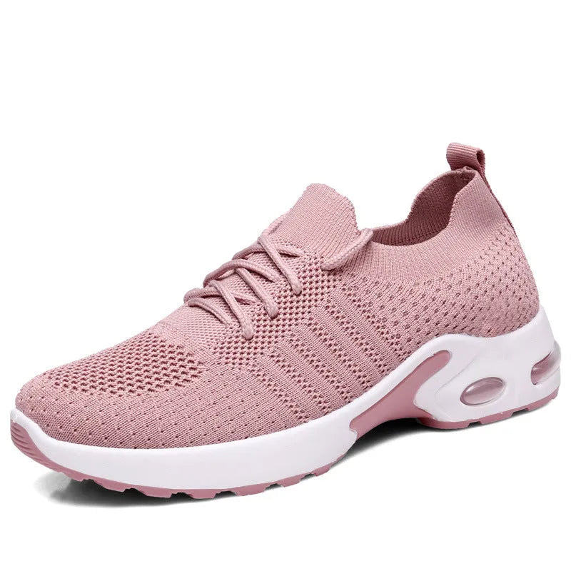 Women's solid-colour mesh sneaker with lace-up front and round toe, shown in grey.