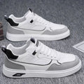 Men's low-top beige canvas board shoes with leather stitching details on a white background.