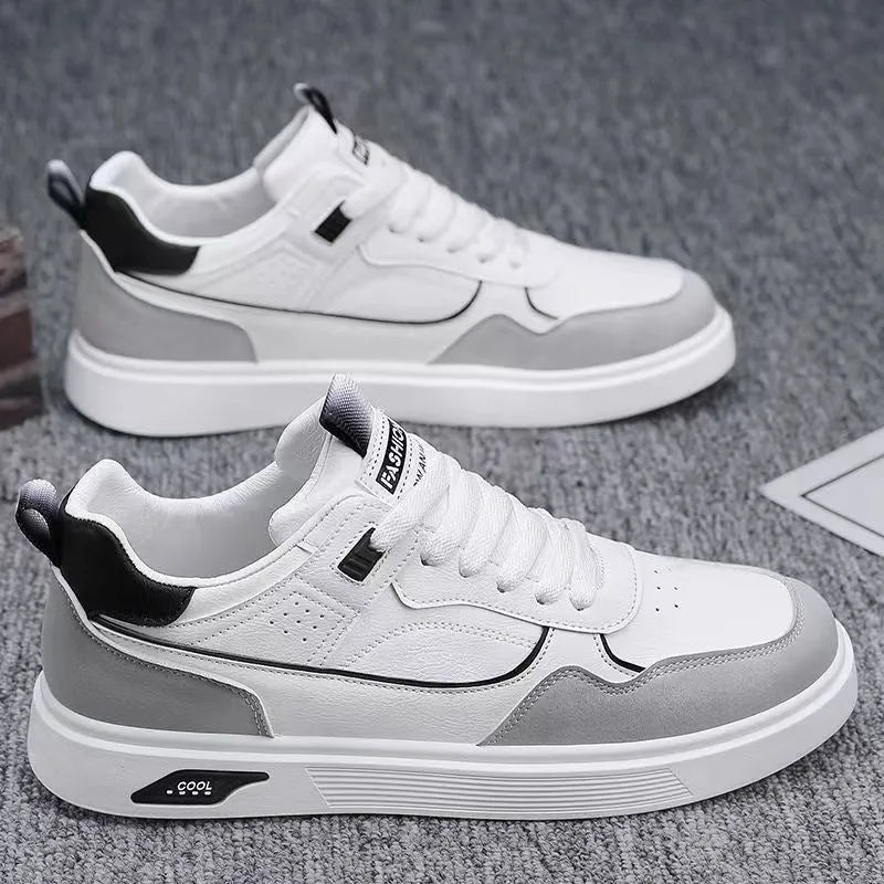 Men's low-top beige canvas board shoes with leather stitching details on a white background.