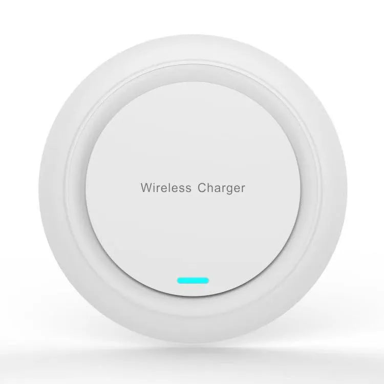 A round, slim 7mm thick 10W desktop wireless phone charger in black or white on a desk.
