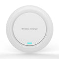 A round, slim 7mm thick 10W desktop wireless phone charger in black or white on a desk.