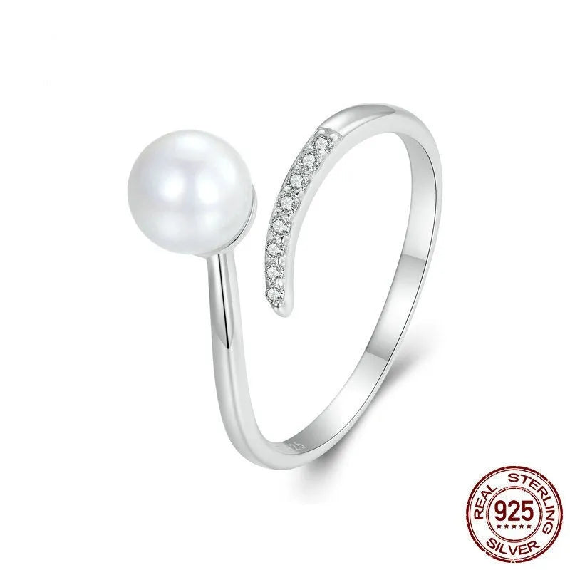 Silver-coloured adjustable open loop ring with a natural white shell pearl setting.