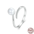 Silver-coloured adjustable open loop ring with a natural white shell pearl setting.