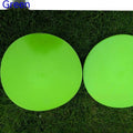 Yellow football training marker disc on grass field showing 23cm diameter flat design