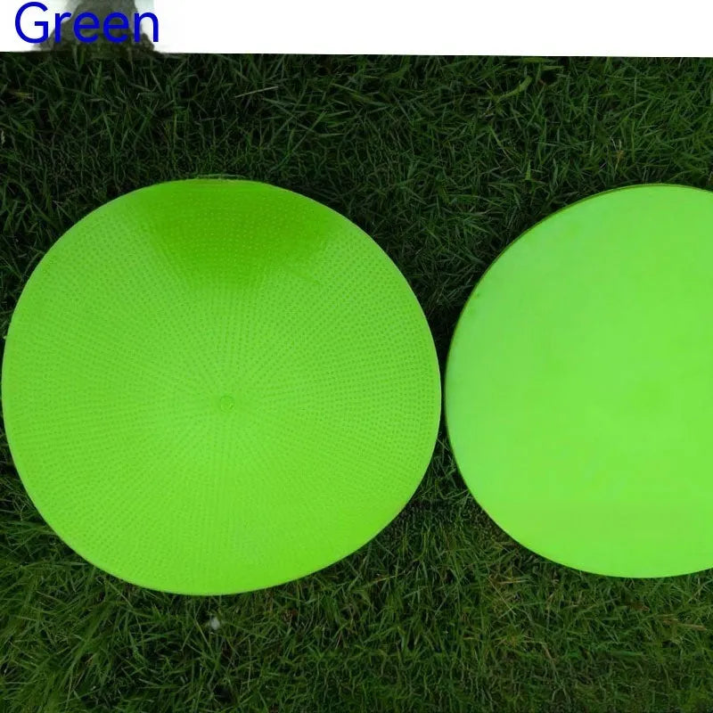 Yellow football training marker disc on grass field showing 23cm diameter flat design