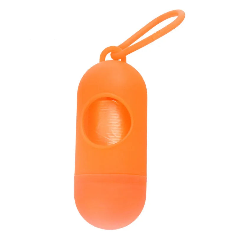 Black plastic dog poop bag dispenser with Velcro strap and a side metal hook.