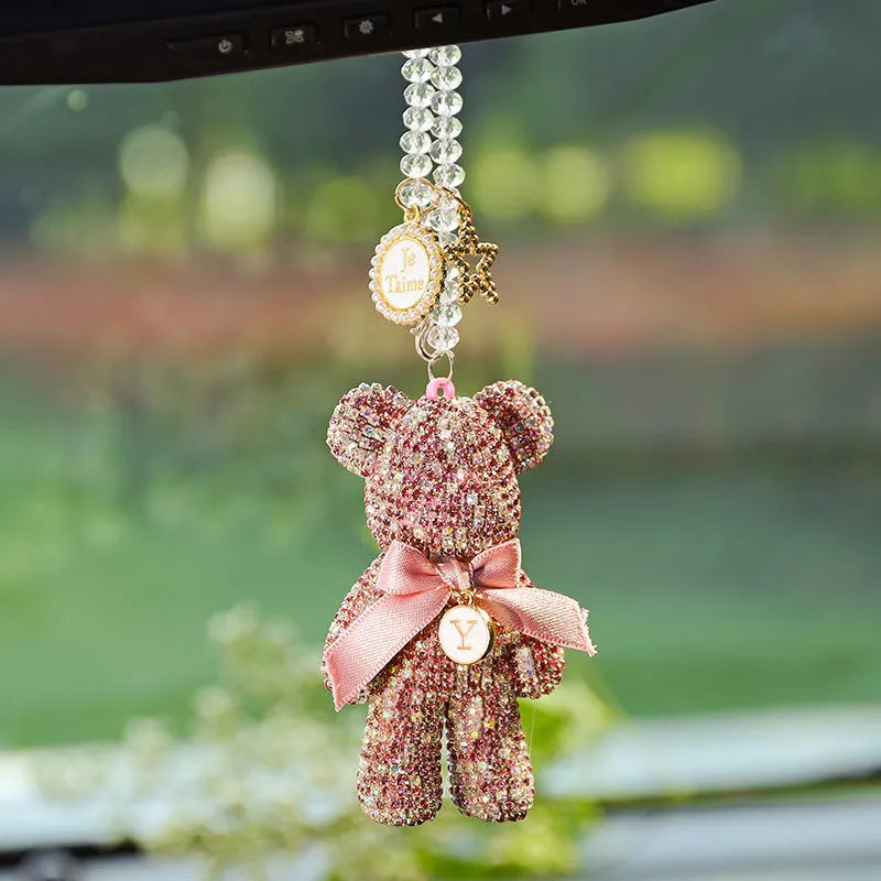 Black violent bear car mirror pendant with embedded crystal rhinestones on a white background.