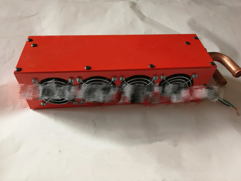 Metal car heater unit with copper pipe radiator and electrical connections for 12V 24V vehicle systems.