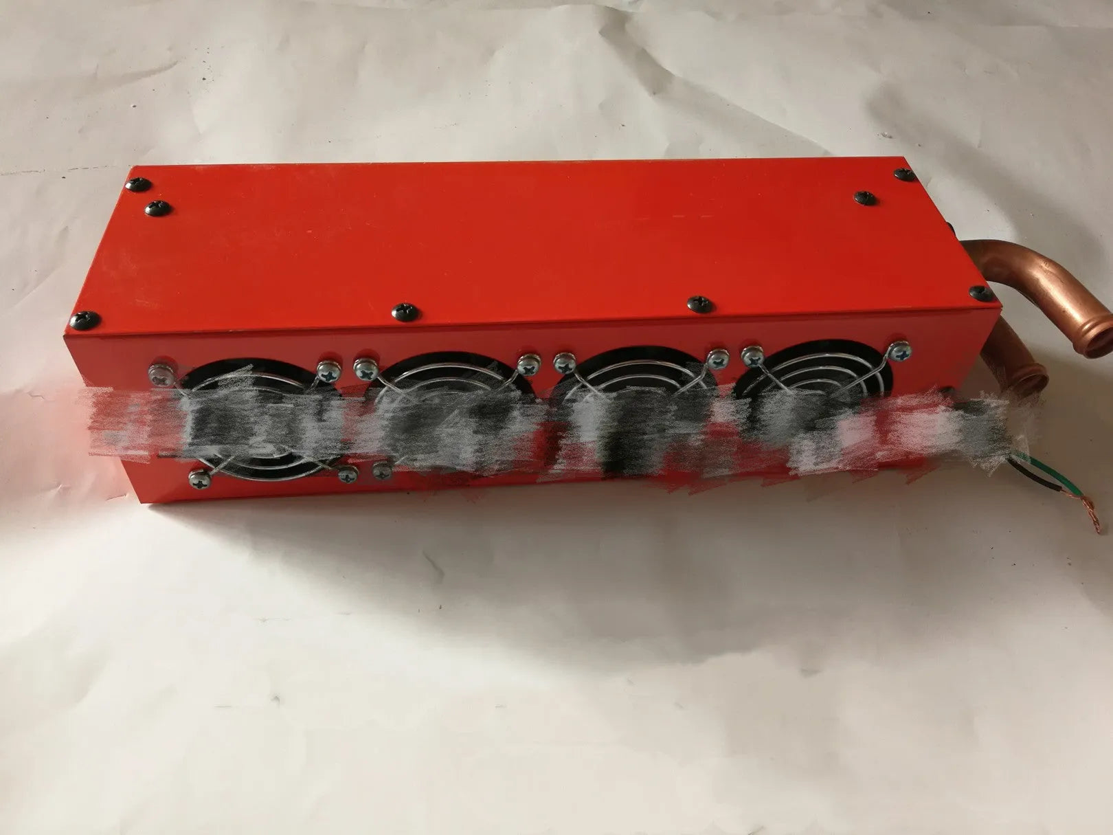 Metal car heater unit with copper pipe radiator and electrical connections for 12V 24V vehicle systems.