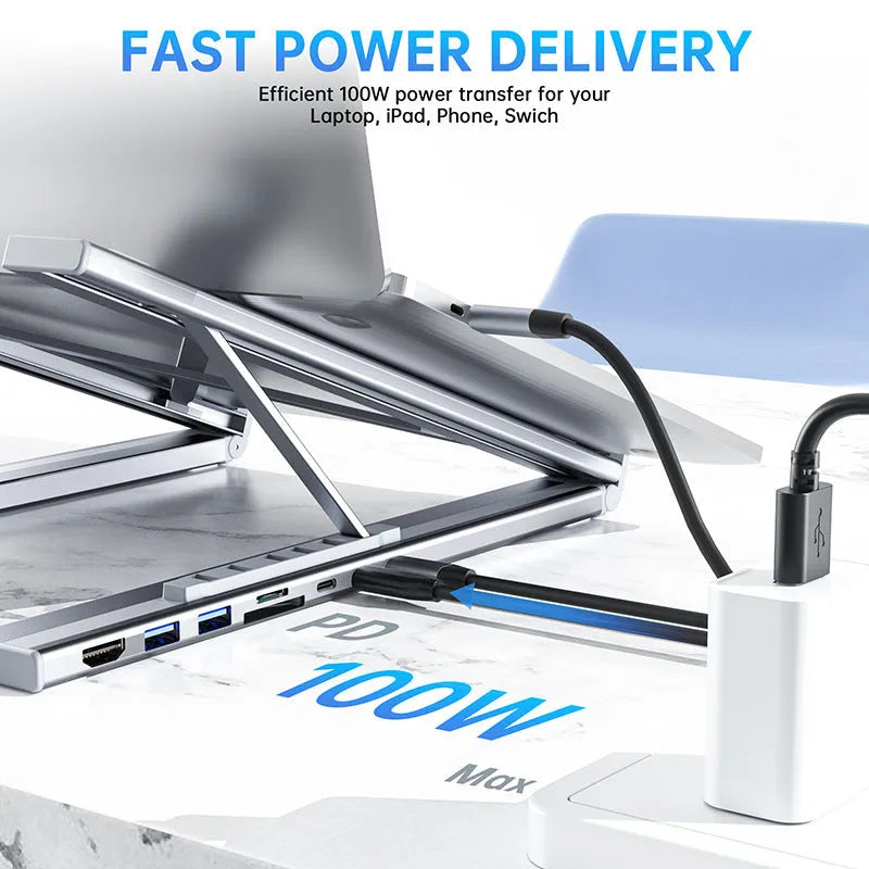 Aluminium folding laptop stand with integrated 8-in-1 docking hub ports and a short cable.