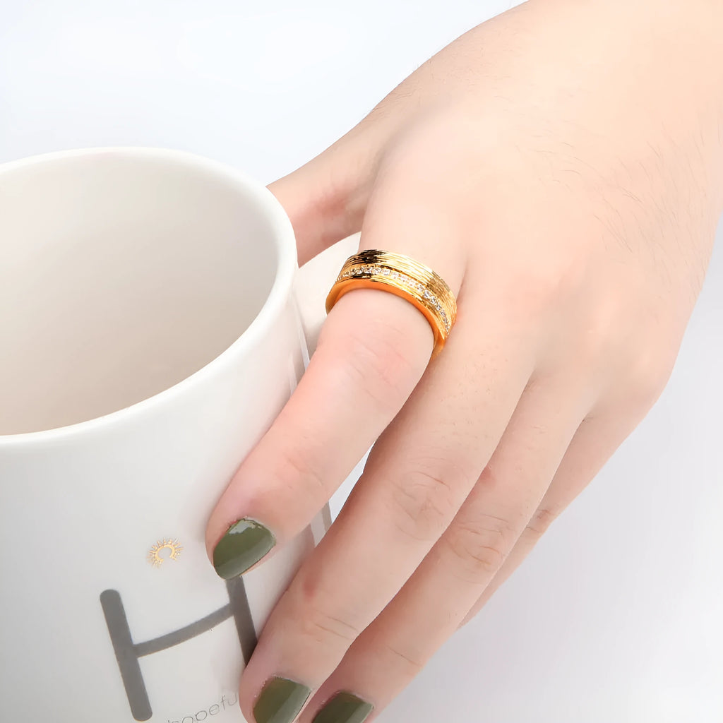Gold geometric zircon ring for women on a white background, showing electroplated copper construction.