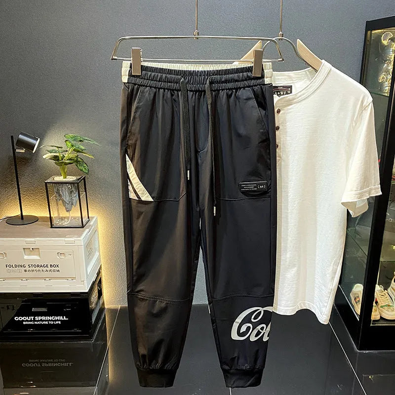 Men's black ankle band trousers with cropped casual fit in lightweight ice silk cotton fabric