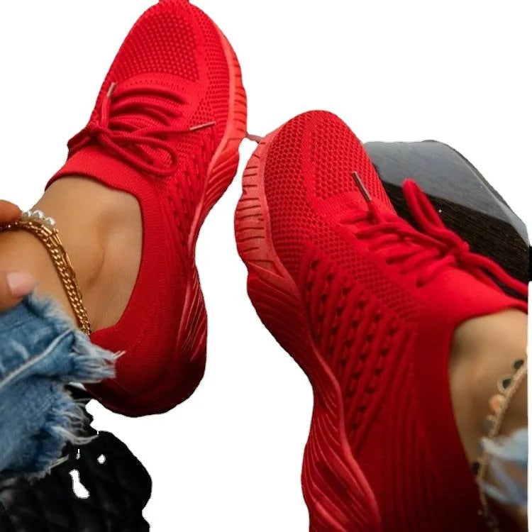 Women's chunky platform sneaker in a solid colour with a thick sole, shown from the side.