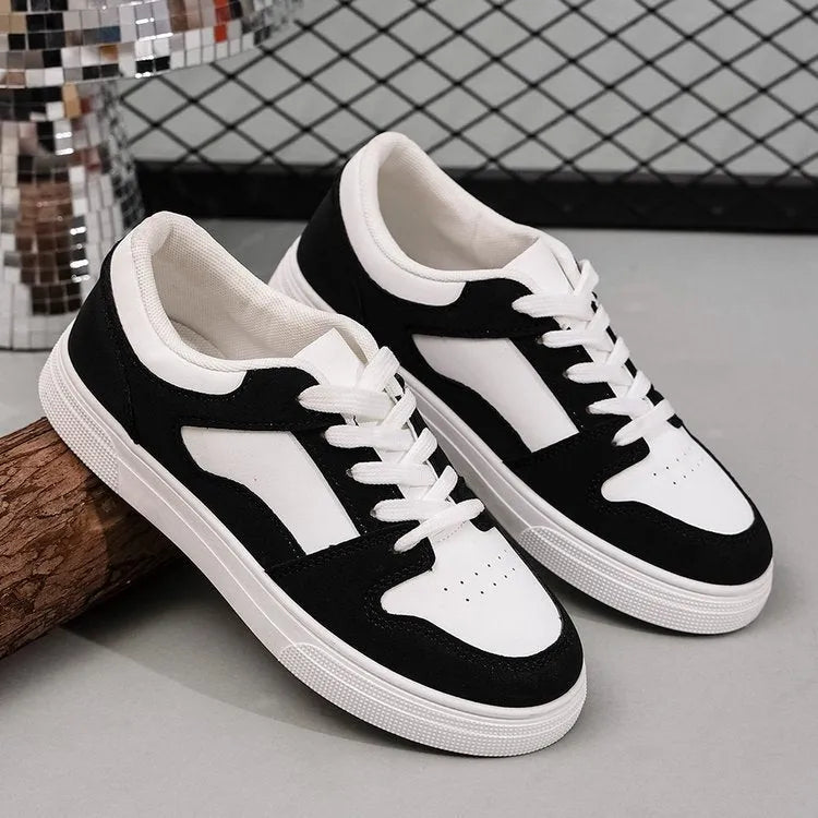 Black women's casual sports shoes with round toe, flat rubber sole, and lace-up front