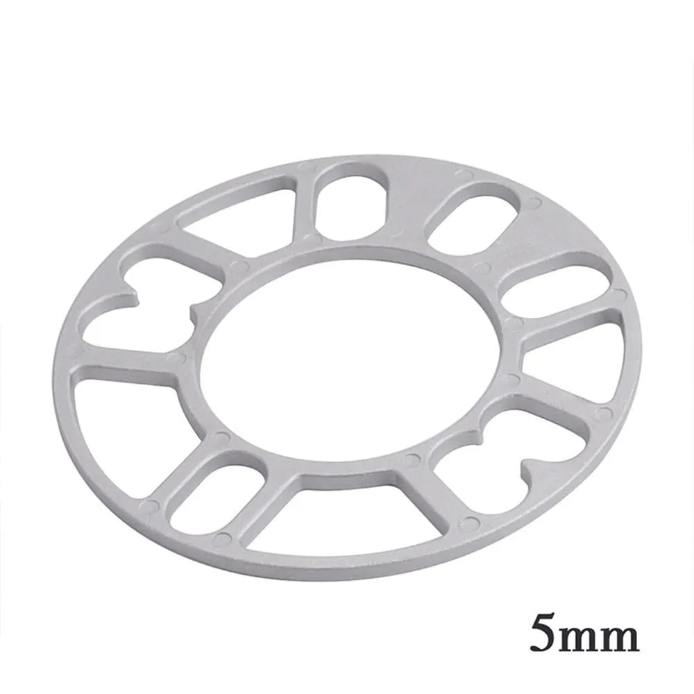 Set of metal hubcentric wheel spacer gaskets in different thicknesses for car brake caliper clearance.