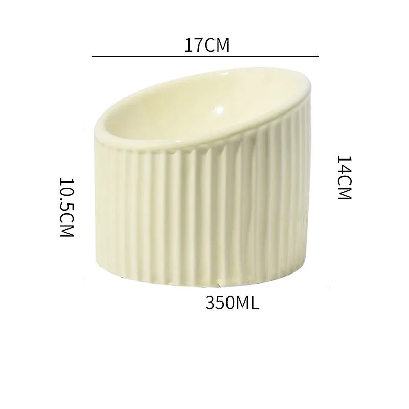 Elevated ceramic cat bowl in light green, showing tilted design and round whisker-friendly shape