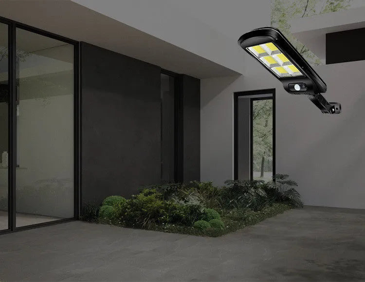 Black solar-powered outdoor motion sensor light with IP65 waterproof rating for garden and driveway security.
