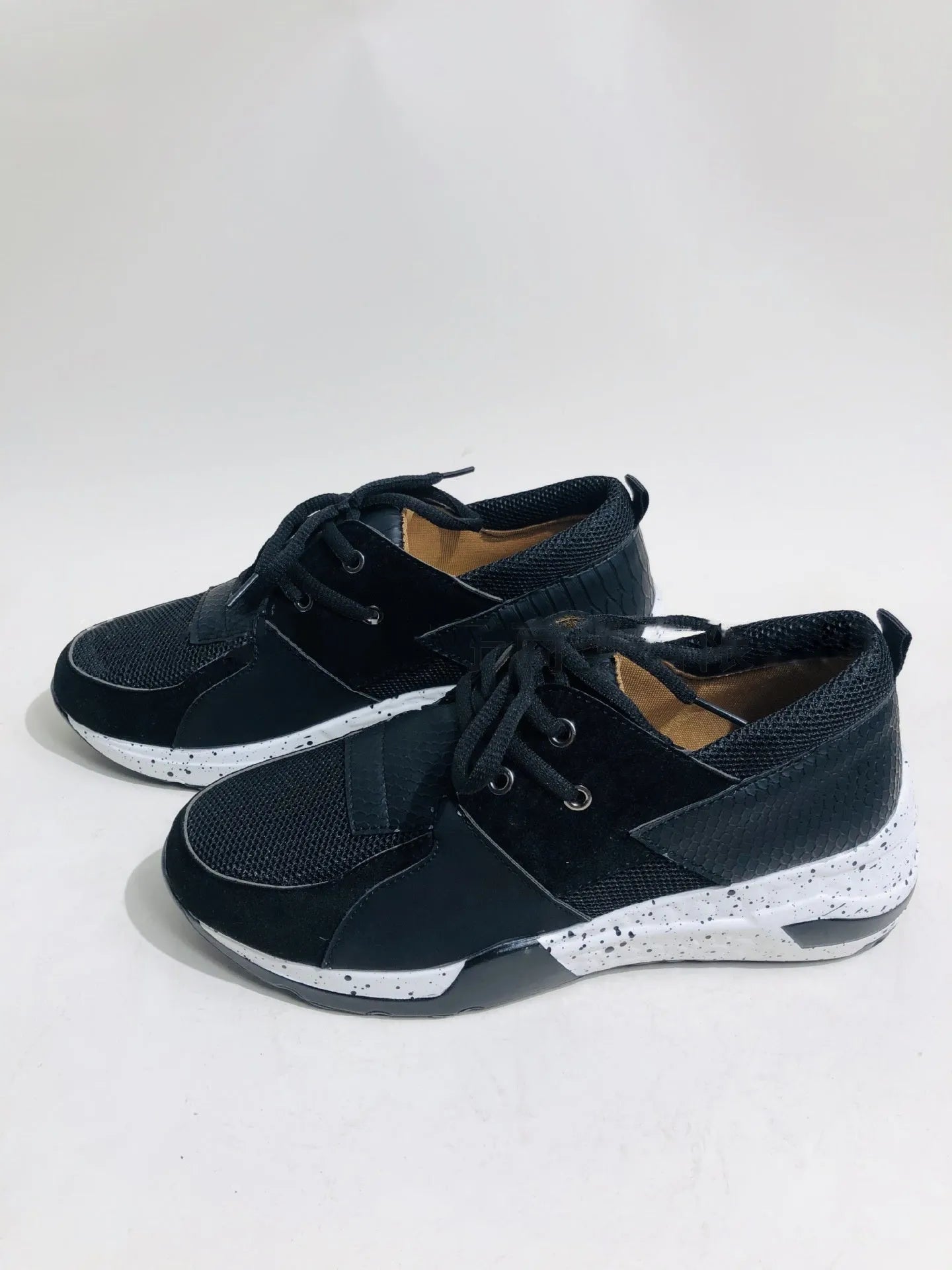 Women's casual suede wedge sneakers in leopard print with a low-cut design and plastic sole.