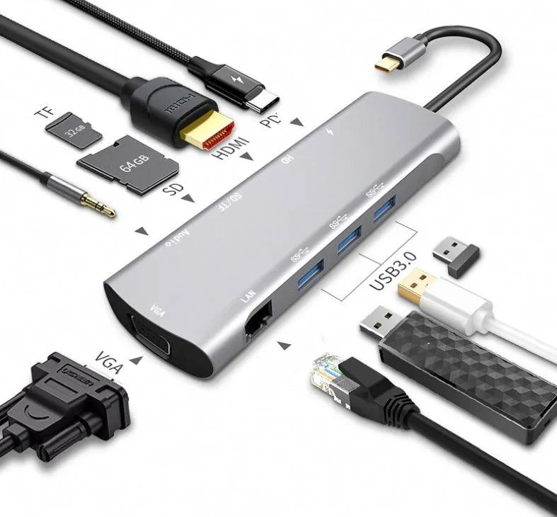 Grey aluminium USB-C docking station with HDMI, VGA, USB 3.0, and PD charge ports on a desk.