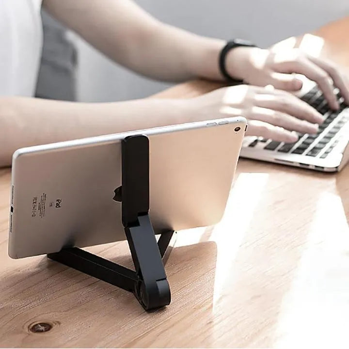 Black foldable tablet holder displaying smartphone in landscape position on desk