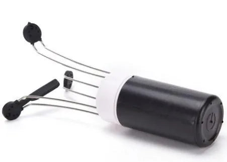 White and black automatic kitchen food stirrer with stainless steel whisk on countertop.